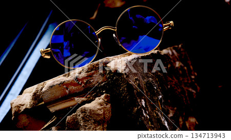 Cool modern vintage gold sunglasses with blue lenses in old brick Cool modern vintage gold sunglasses with blue lenses in old brick 134713943