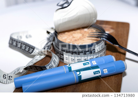 Weight loss concept featuring tuna fish and ozempic pen. Weight loss concept featuring tuna fish and ozempic pen. 134713980
