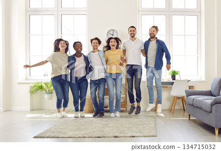 Group of cheerful multiracial friends hugging each other and jumping all together Group of cheerful multiracial friends hugging each other and jumping all together 134715032