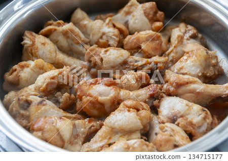 Spicy chicken wings cooking in a pot Spicy chicken wings cooking in a pot 134715177