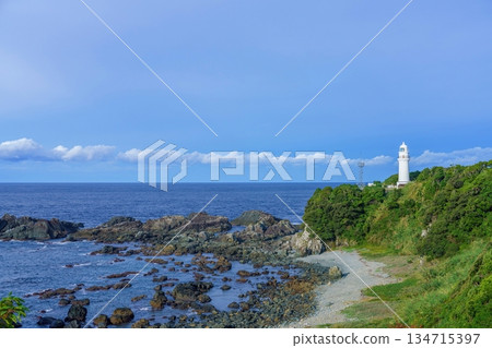 A collaborative scene of Shionomisaki Lighthouse and the Pacific Ocean against a blue sky A collaborative scene of Shionomisaki Lighthouse and the Pacific Ocean against a blue sky 134715397
