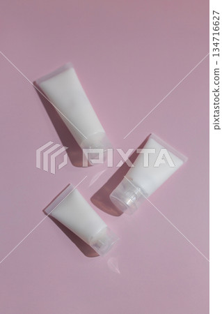 Minimalist skincare mockup with blank cosmetic tubes on soft pink background, perfect for beauty branding, product design, packaging presentation and modern cosmetics advertising. Minimalist skincare mockup with blank cosmetic tubes on soft pink background, perfect for beauty branding, product design, packaging presentation and modern cosmetics advertising. 134716627