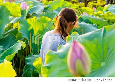 Lotus flower and woman from behind 134716837