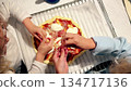 Two children cooking homemade pizza together in kitchen, overhead view 134717136