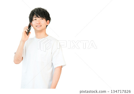 Young Asian man making a phone call on his smartphone Young Asian man making a phone call on his smartphone 134717826