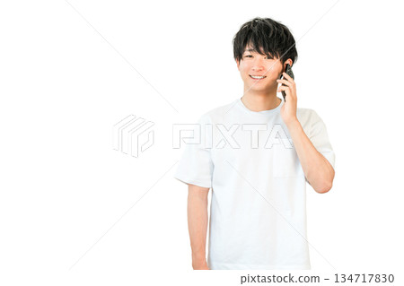 Young Asian man making a phone call on his smartphone Young Asian man making a phone call on his smartphone 134717830