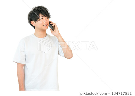 Young Asian man making a phone call on his smartphone Young Asian man making a phone call on his smartphone 134717831