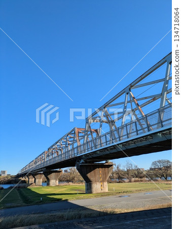 A railway bridge under a clear blue sky. A truss bridge with depth (vertical) A railway bridge under a clear blue sky. A truss bridge with depth (vertical) 134718064