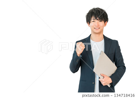 A young man of the digital native generation holding a computer (fist pump, motivation, success) A young man of the digital native generation holding a computer (fist pump, motivation, success) 134718416