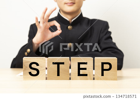 A male student making an OK sign with a block that says "STEP" A male student making an OK sign with a block that says "STEP" 134718571