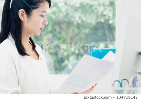 Young woman doing office work 134719142