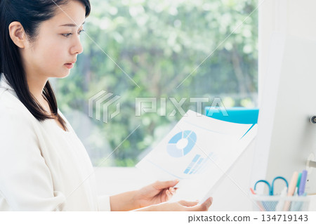 Young woman doing office work 134719143