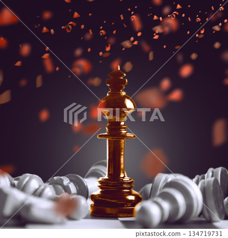Golden king chess piece standing victorious over fallen white pieces with red confetti falling in the background. Concept of Winner 134719731