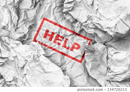 Crumpled white paper with a red rectangular stamp containing the word "HELP". The image can represent concepts of stress, asking for support, crisis, or needing assistance Crumpled white paper with a red rectangular stamp containing the word "HELP". The image can represent concepts of stress, asking for support, crisis, or needing assistance 134720213