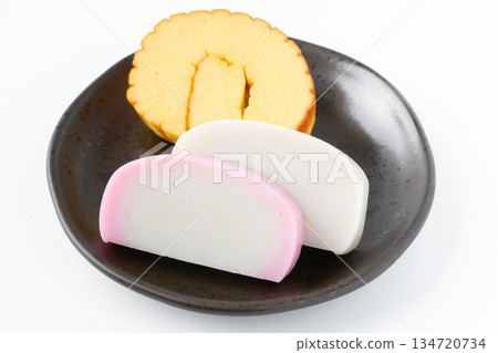 Datemaki and red and white kamaboko served on a plate on a white background Datemaki and red and white kamaboko served on a plate on a white background 134720734
