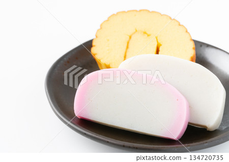 Datemaki and red and white kamaboko served on a plate on a white background Datemaki and red and white kamaboko served on a plate on a white background 134720735