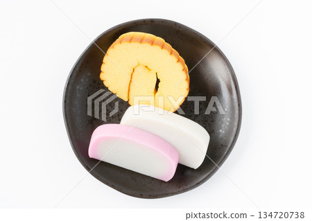 Datemaki and red and white kamaboko served on a plate on a white background Datemaki and red and white kamaboko served on a plate on a white background 134720738