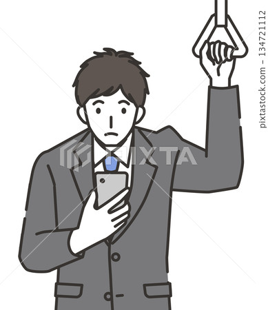 Office worker looking at smartphone on commuter train 134721112