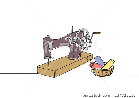 Continuous line draw of vintage sewing machine next to basket filled with rolls of colorful fabric. Symbolize the timeless connection between sewing tools and materials.  National Sewing Machine Day 134722135