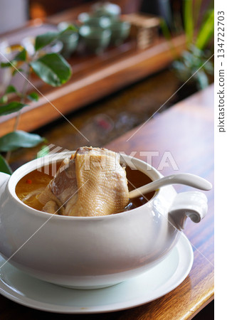 Tasty chicken soup in white bowl Tasty chicken soup in white bowl 134722703