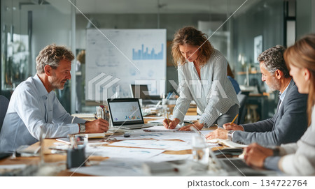 Focused team collaborating on financial dashboard Focused team collaborating on financial dashboard 134722764