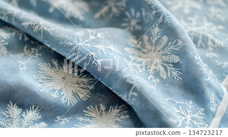 A blue fabric with white snowflakes on it 134723217