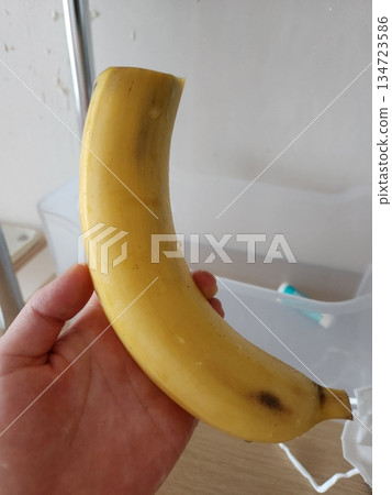 A single ripe banana with smooth yellow skin and slightly curved shape, showcasing its natural color and fresh appearance as a simple and healthy tropical fruit A single ripe banana with smooth yellow skin and slightly curved shape, showcasing its natural color and fresh appearance as a simple and healthy tropical fruit 134723586