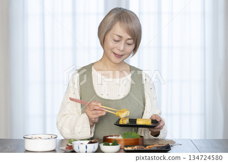 一位老婦人在廚房做午餐 一位老婦人在廚房做午餐 134724580
