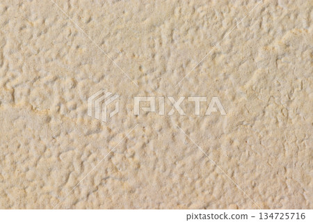 Light brown wall with small irregularities on the surface Light brown wall with small irregularities on the surface 134725716
