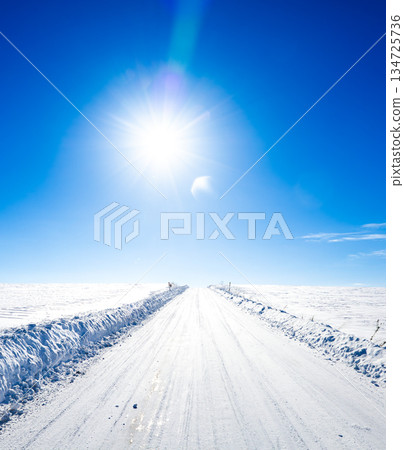 Winter scenery of Biei, Hokkaido, with blue sky, sun and packed snow and icy roads Winter scenery of Biei, Hokkaido, with blue sky, sun and packed snow and icy roads 134725736