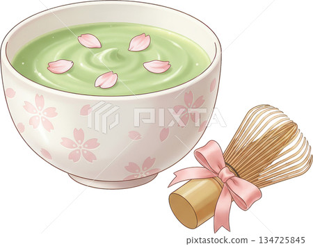 Green matcha tea in a decorative bowl with pink petals and a bamboo whisk 134725845