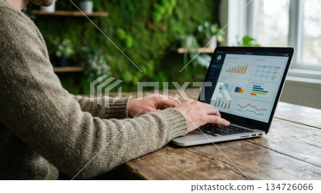 Person Working on Laptop in Eco Friendly Office with Green Moss Wall Person Working on Laptop in Eco Friendly Office with Green Moss Wall 134726066