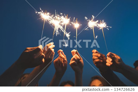 people holding sparkler on the background of the night 134726626
