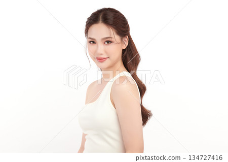 A beautiful young Asian woman with clean, fresh skin against a white background. Skincare, facial treatment, cosmetology, beauty, and spa. An elegant portrait of an Asian woman. 134727416