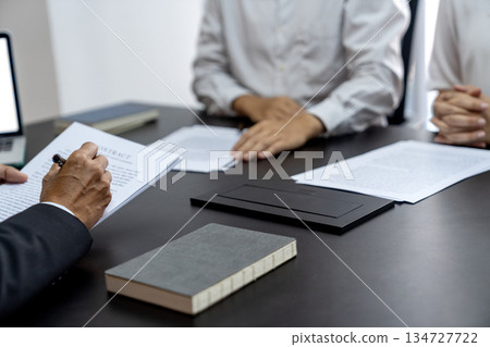 The lawyer is writing down the messages heard from the client to collect 134727722