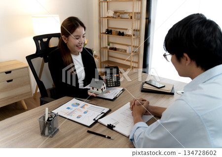 Young business woman is talking about presenting real estate Young business woman is talking about presenting real estate 134728602