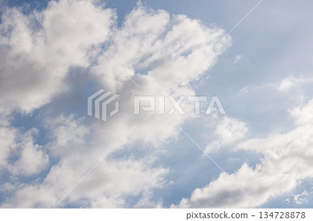 Bright Blue Sky with Fluffy White Clouds. Nature Background. Weather Concept. Heaven Atmosphere. High quality photo 134728878