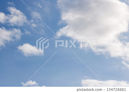Bright Blue Sky with Scattered White Cumulus Clouds. Heaven Atmosphere. peaceful air. Nature Background. High quality photo 134728881