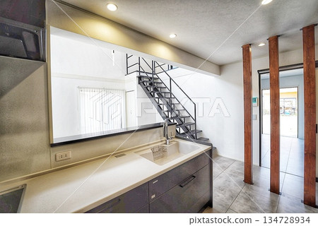 Stylish living room and kitchen with open ceiling Stylish living room and kitchen with open ceiling 134728934