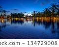 Resort swimming pool in Mauritius with palm trees and lights after sunset. 134729008