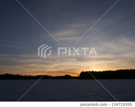 Beautiful sunset over a field of snow Beautiful sunset over a field of snow 134729309