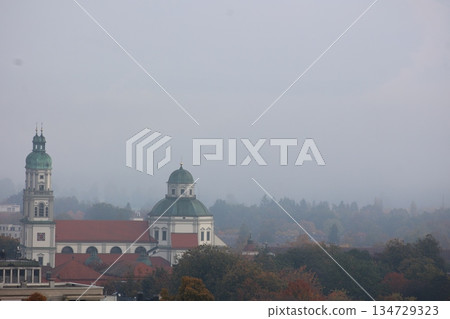 Foggy day with a church and a tower in the background 134729323