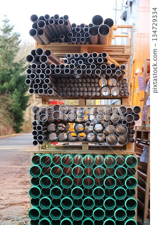 Storage of metal and plastic pipes in an outdoor setting Storage of metal and plastic pipes in an outdoor setting 134729334