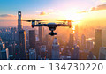 Modern drone flying over a city skyline at sunset. Concept of aerial technology, urban innovation, drone photography, and futuristic digital lifestyle. Ready for stock and advertising use. 134730220
