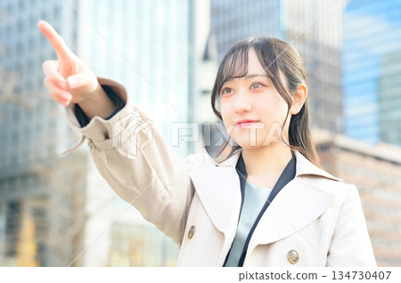 A woman pointing in an office district A woman pointing in an office district 134730407