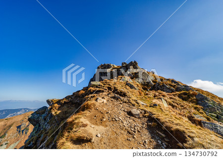 Autumn hiking trail on the ridge of Low Tatras mountains, Slovakia. Autumn hiking trail on the ridge of Low Tatras mountains, Slovakia. 134730792