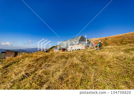 Mountain hut Stefanikova chata in Low Tatras mountains, Slovakia, during autumn season with hikers. 134730820