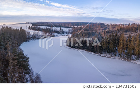 Aerial View of a Frozen Lake in a Forest During Winter. Highland, Vysocina, Czech Republic Aerial View of a Frozen Lake in a Forest During Winter. Highland, Vysocina, Czech Republic 134731502