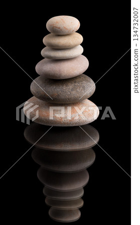 Balanced Stone Cairn on Black Reflective Surface 134732007