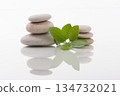 Zen Stones and Green Leaves on White Reflective Surface 134732021
